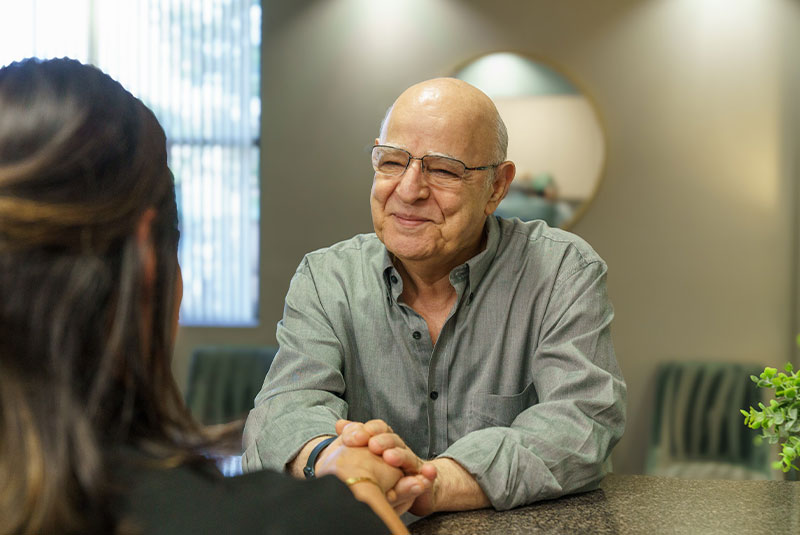 staff member welcoming patient into office